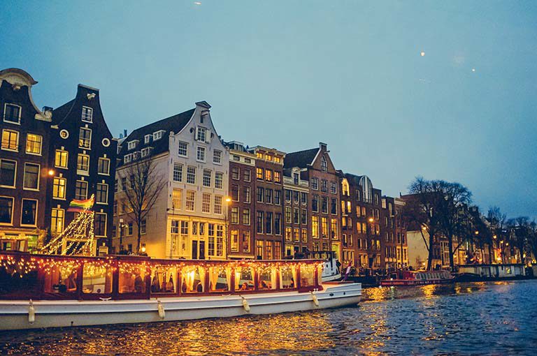 Waterfront houses in Amsterdam, Netherlands at dusk